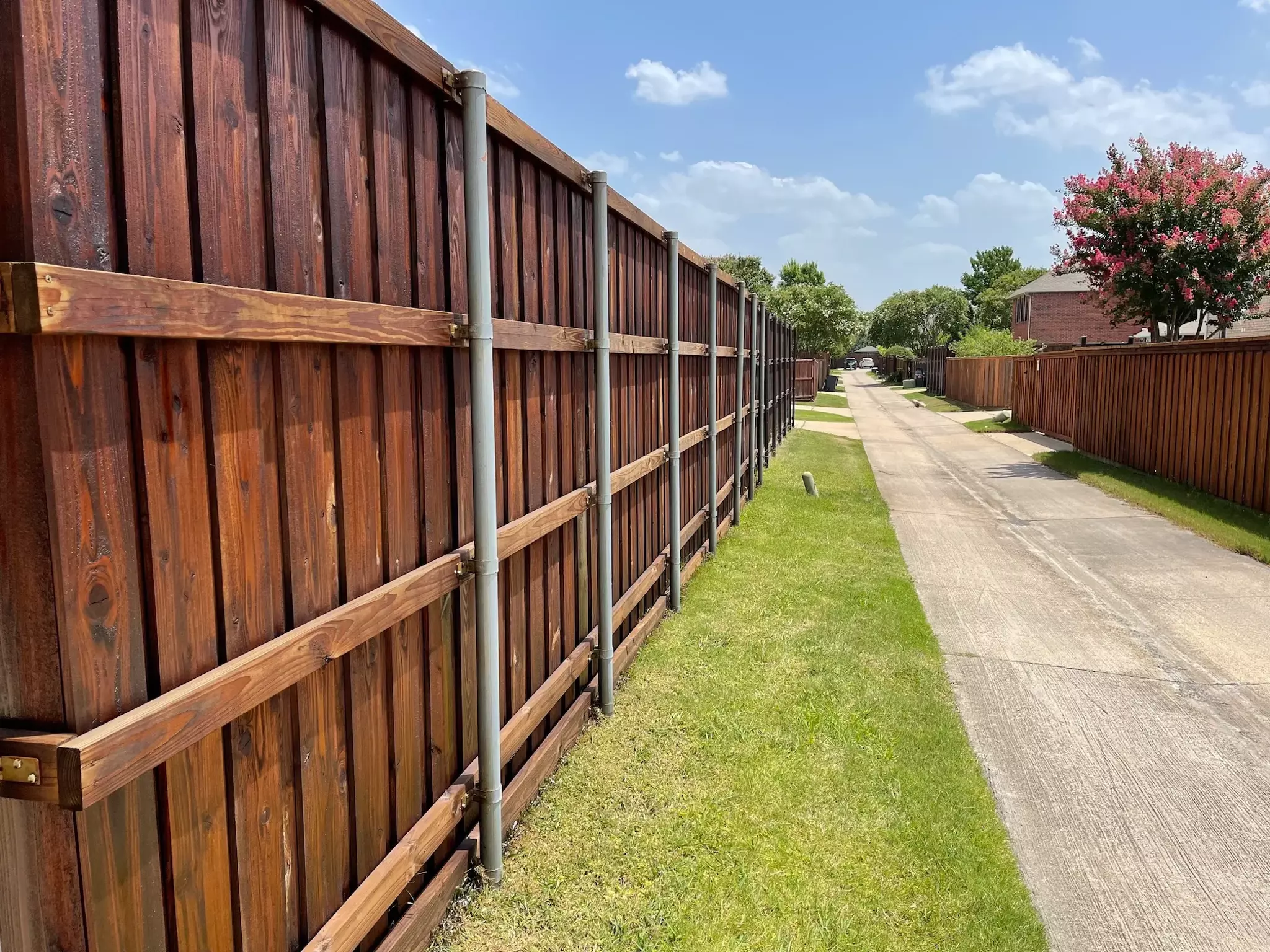 Brown stained wooden fence in a residential alleyway