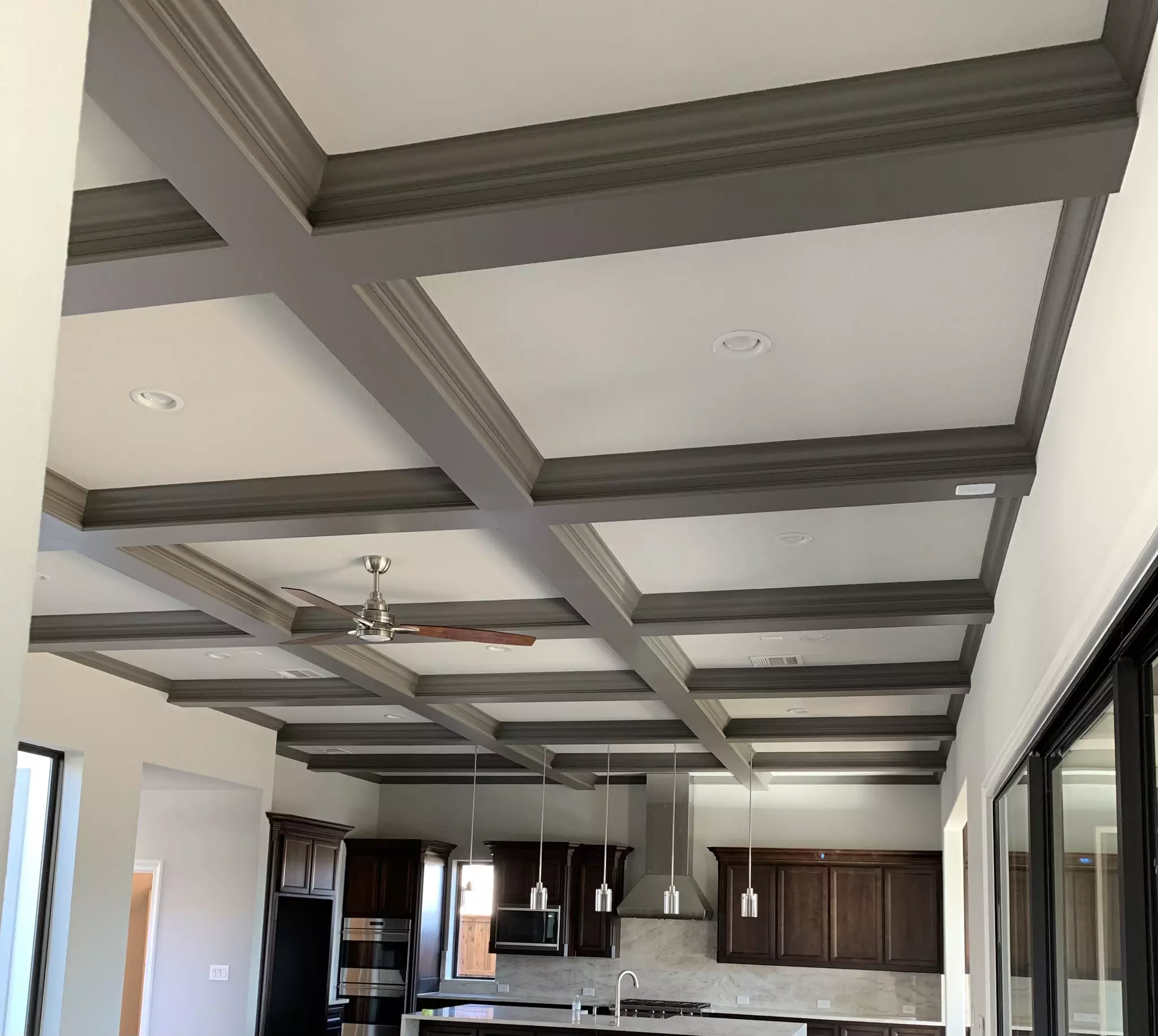 Offwhite painted ceiling with grid of gray painted extruded ceiling accent pieces